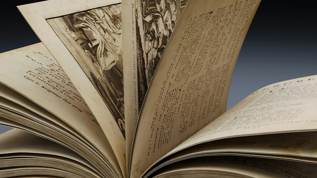 Open antique book with aged pages