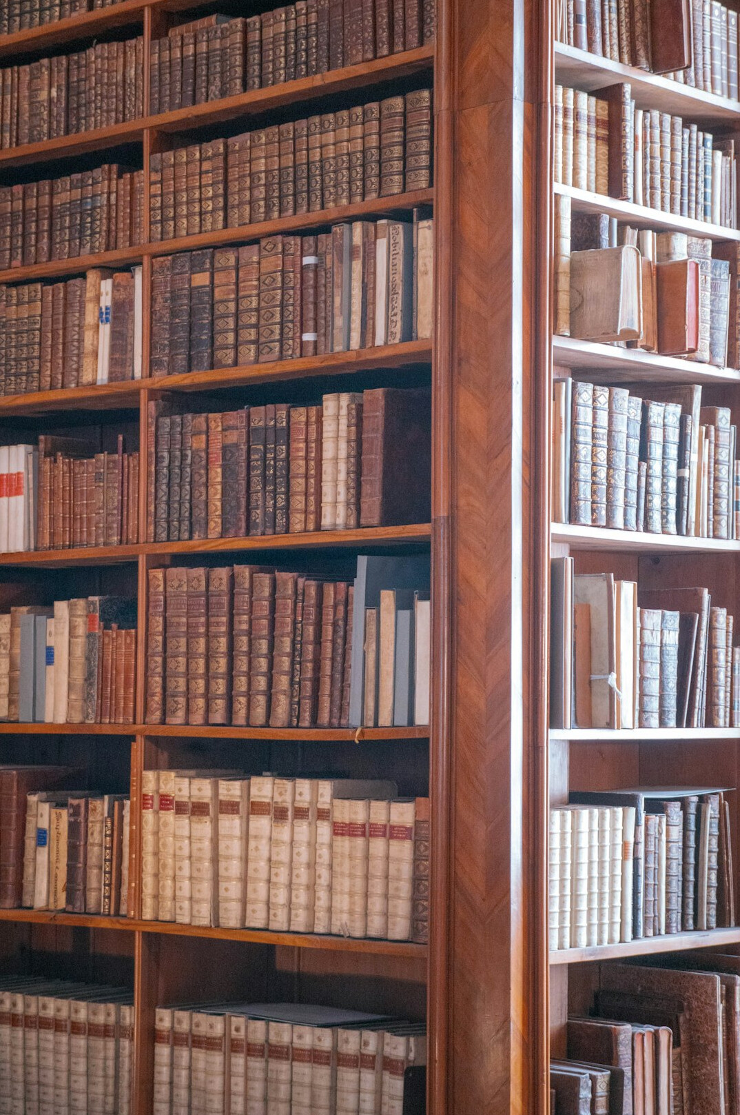Old library with tall wooden bookshelves
